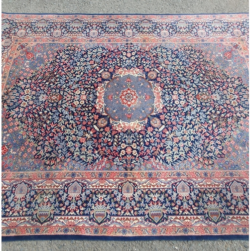 929 - A bordered Persian Carpet with central indigo medallion on a red field with indigo main border, 6ft ... 