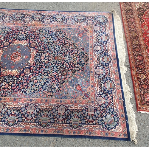 929 - A bordered Persian Carpet with central indigo medallion on a red field with indigo main border, 6ft ... 