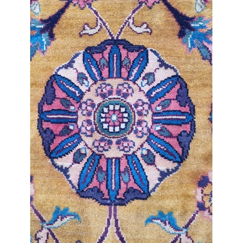 935 - A modern woolen Persian style Rug with trailing floral design on mustard ground within wide green bo... 