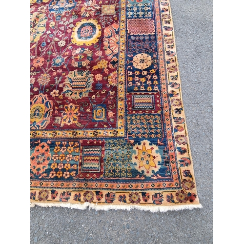 939 - A Oushak type bordered Carpet on red and blue ground, the borders with stylised floral designs, the ... 