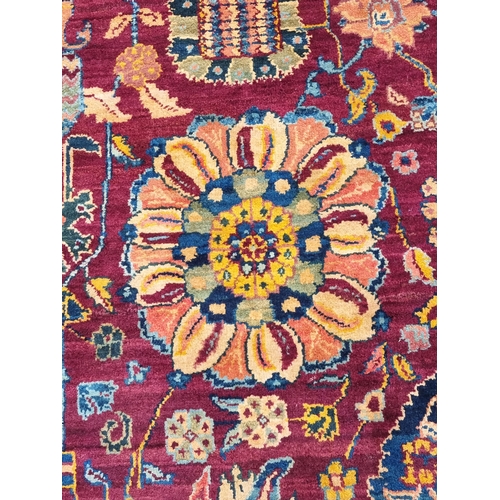 939 - A Oushak type bordered Carpet on red and blue ground, the borders with stylised floral designs, the ... 