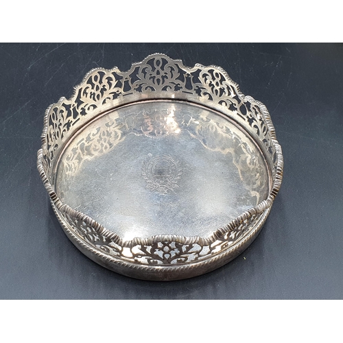 96 - A Set of four Victorian silver Wine Coasters and another, larger en suite, circular the shaped sides... 