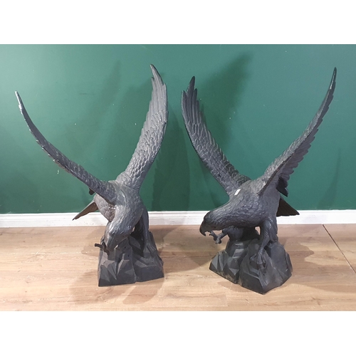 805 - A pair of black cast metal Figures of Eagles with wings spread, 3ft 10in H