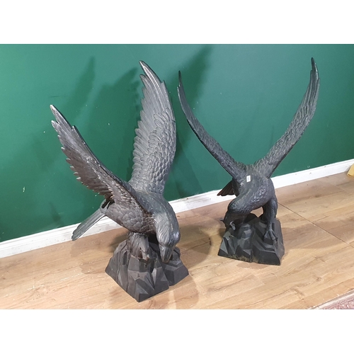 805 - A pair of black cast metal Figures of Eagles with wings spread, 3ft 10in H