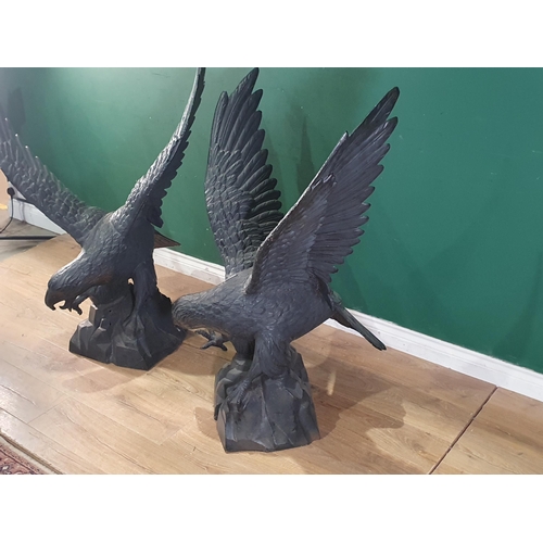 805 - A pair of black cast metal Figures of Eagles with wings spread, 3ft 10in H