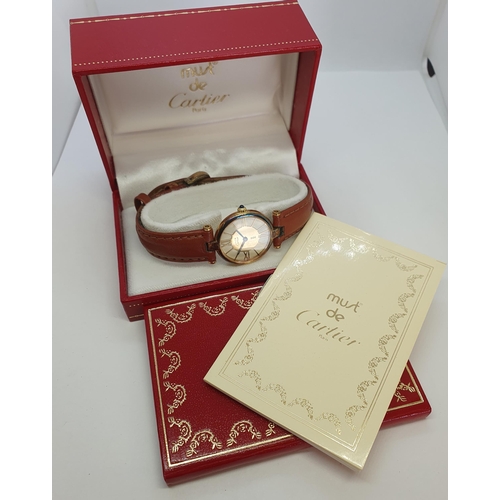 123 - A Vintage (1980s) lady's Must de Cartier Wristwatch having champagne dial with applied gold coloured... 