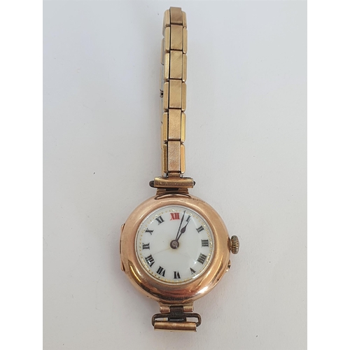 124 - A 1930's lady's Wristwatch in 9ct gold case, having white enamel dial with Roman numerals and applie... 