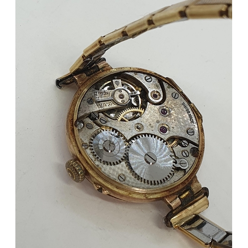 124 - A 1930's lady's Wristwatch in 9ct gold case, having white enamel dial with Roman numerals and applie... 