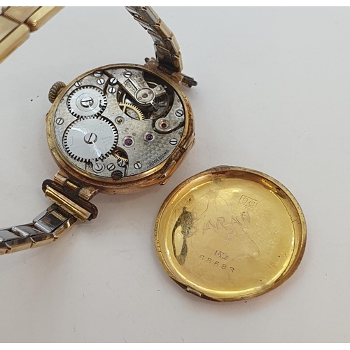 124 - A 1930's lady's Wristwatch in 9ct gold case, having white enamel dial with Roman numerals and applie... 