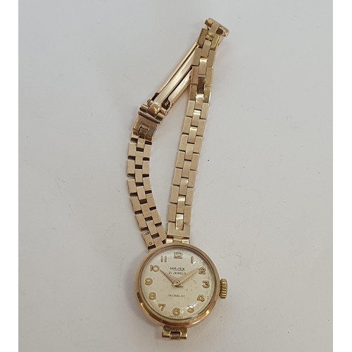 129 - A lady's vintage Majex Wristwatch the champagne enamel dial having applied gold Arabic numerals in 9... 