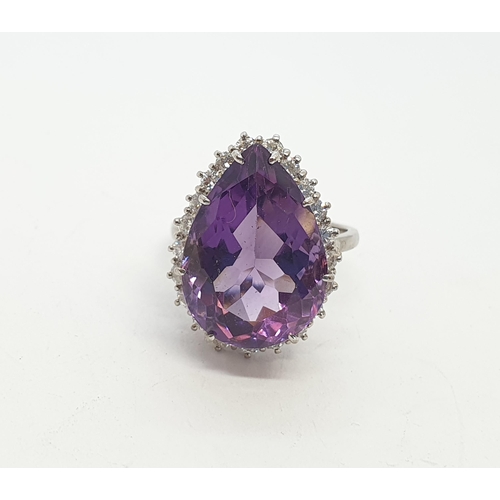 165 - A pear-shaped Amethyst & Diamond Ring claw-set large mixed-cut amethyst surrounded by twenty one rou... 