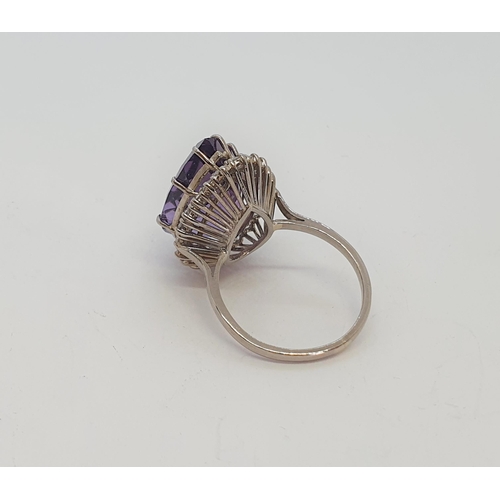 165 - A pear-shaped Amethyst & Diamond Ring claw-set large mixed-cut amethyst surrounded by twenty one rou... 