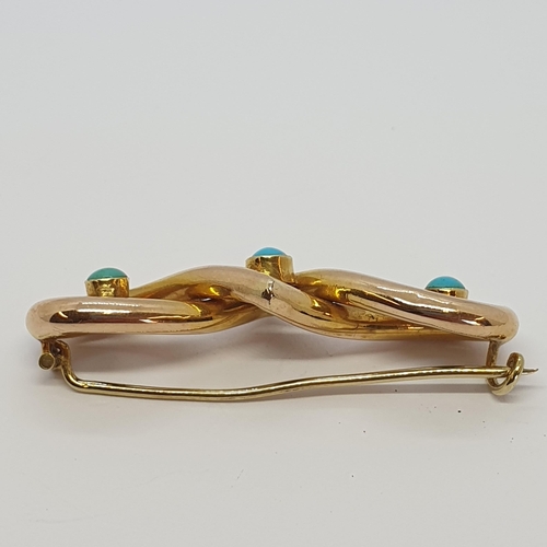 172 - A gold Knot Brooch set three turquoise cabochons, approx 45mm long, approx 3.80gms