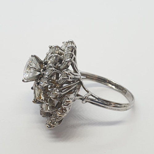 181 - A Diamond Cocktail Ring (centre stone replaced with CZ) of asymmetric swirl effect claw-set brillian... 