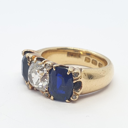 193 - A fine Victorian Diamond & Burmese Sapphire Three Stone Ring claw-set cushion-cut diamond flanked by... 