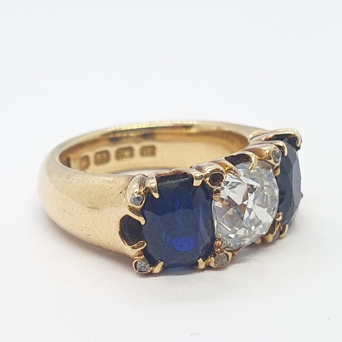 193 - A fine Victorian Diamond & Burmese Sapphire Three Stone Ring claw-set cushion-cut diamond flanked by... 