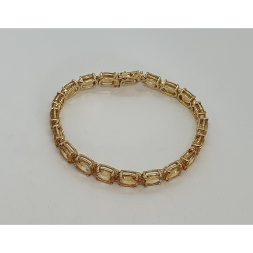 201 - A Citrine Line Bracelet claw-set 20 oval mixed cut citrines in 14ct gold, stamped 14k, 18cm, approx ... 