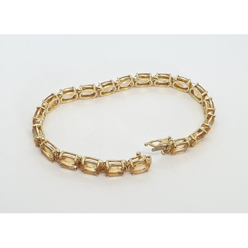 201 - A Citrine Line Bracelet claw-set 20 oval mixed cut citrines in 14ct gold, stamped 14k, 18cm, approx ... 