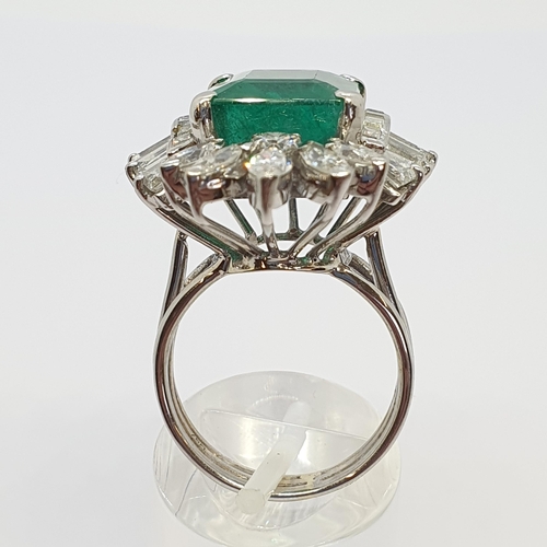 204 - An Emerald and Diamond Cocktail Ring corner claw-set octagonal mixed-cut emerald estimated 10.20cts,... 