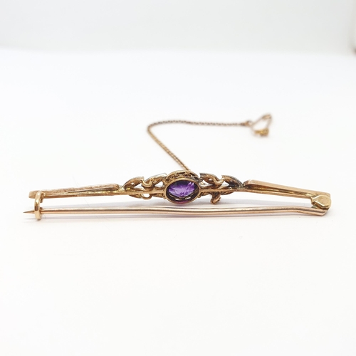 207 - An Amethyst and Diamond Bar brooch millegrain-set round amethyst between pairs of leaves set rose-cu... 