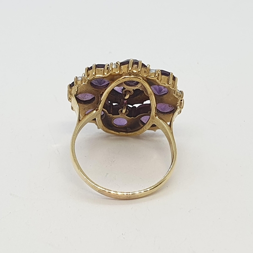 215 - An Amethyst & Pearl Cluster Ring with central rubover set round mixed-cut amethyst surrounded by rin... 