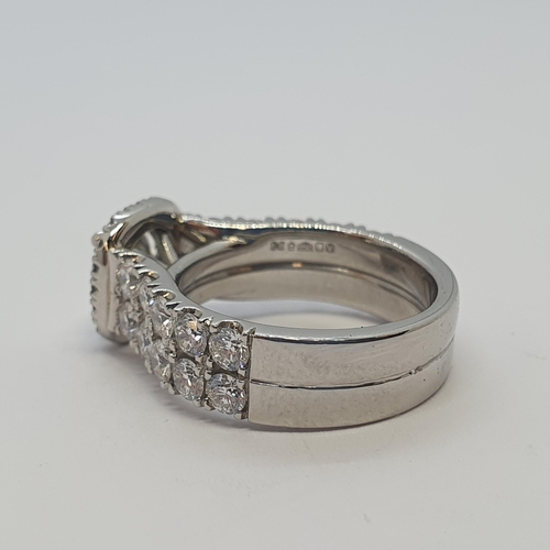 222 - A contemporary Diamond Cluster Ring claw-set brilliant-cut stone, 1.02cts, within a frame of pavé-se... 