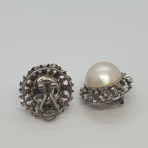 227 - A pair of Mabé Pearl Ear Clips each set large half pearl within  openwork frame formed as garland of... 