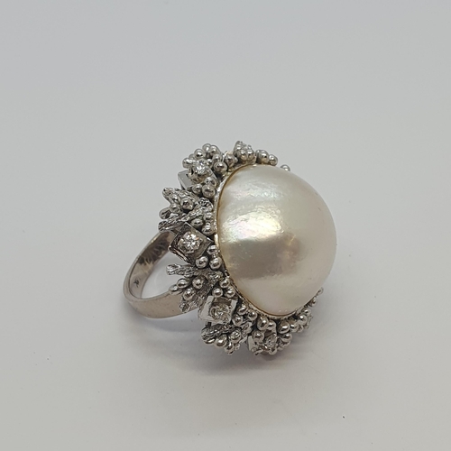 228 - A Mabé Pearl and Diamond Cocktail Ring set large pearl within intricate frame claw-set brilliant-cut... 