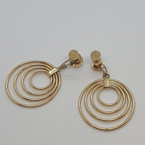 229 - A pair of Hoop Earrings each having four concentric rings, stamped 14K, on screw fittings, approx 48... 