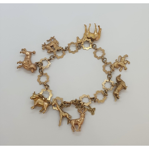 236 - A 9ct gold star link Bracelet with numerous charms, approx 28gms