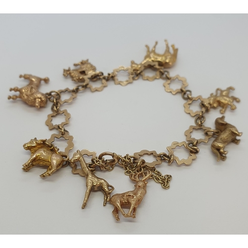 236 - A 9ct gold star link Bracelet with numerous charms, approx 28gms