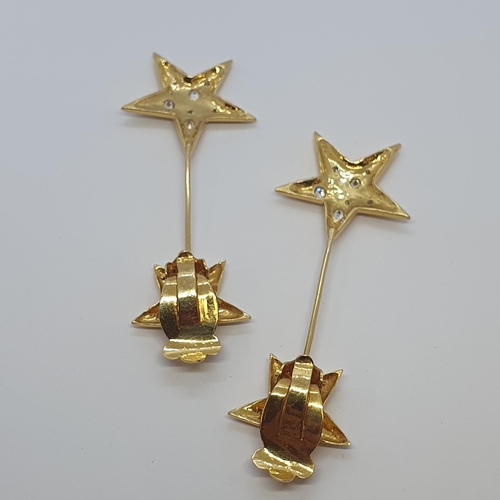 237 - A pair of Diamond Star Ear Clips each with five point star rubover-set brilliant-cut stones suspendi... 