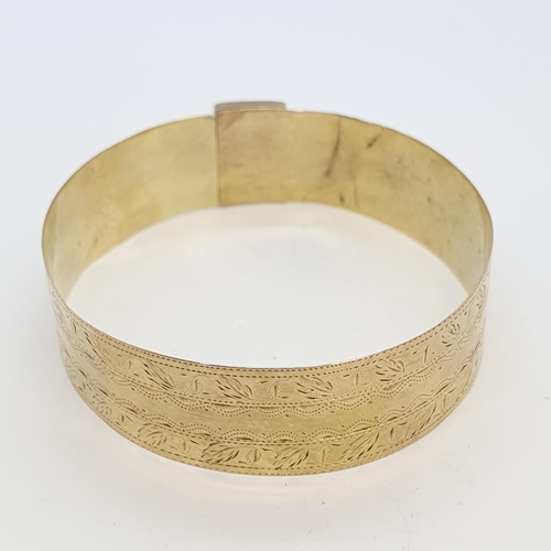 244 - A rigid gold Bangle with bright-cut engraving, approx 12.50gms, unmarked, untested