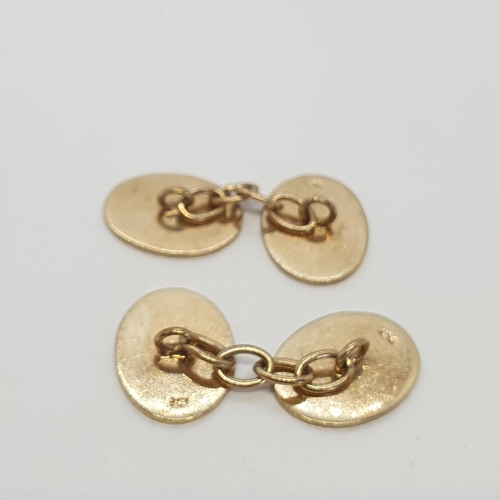 257 - A pair of oval Cufflinks with chain connectors, stamped 9ct, length of plaque 18mm, approx 8.8gms