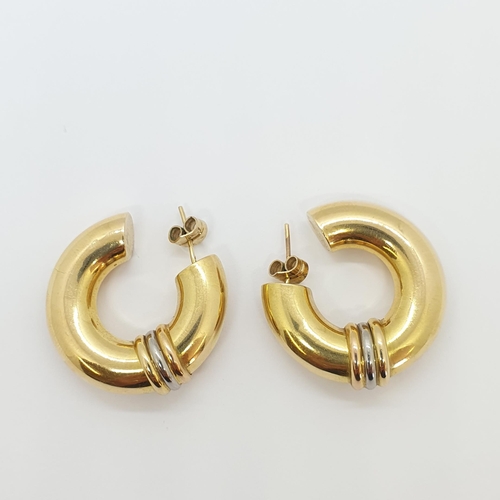 273 - A pair of large Hoop Earrings, the hollow hoops having a three colour gold decorative band, on post ... 