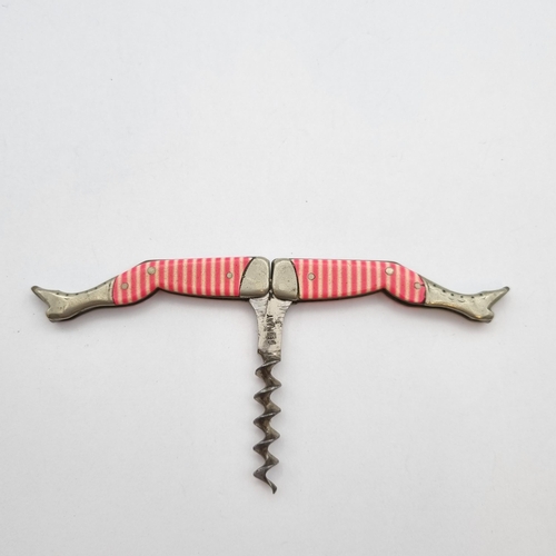 294 - A novelty Corkscrew formed as a pair of striped stockinged legs, stamped GERMANY