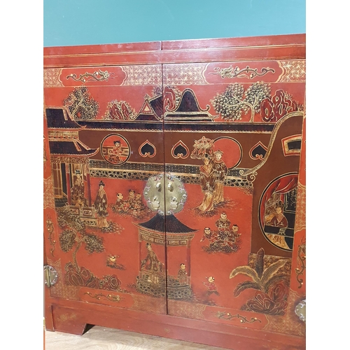 629 - A Chinese red lacquered Cupboard with double-hinged top above a pair of cupboard doors decorated fig... 