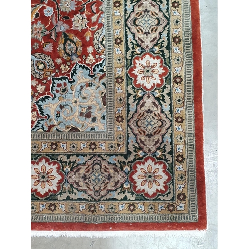 942 - A Persian style fine wool Rug with flower head design to the borders and having central rosette on a... 