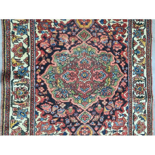 932 - A bordered Persian Runner with geometric floral field in red, blue, cream, etc within tramline borde... 