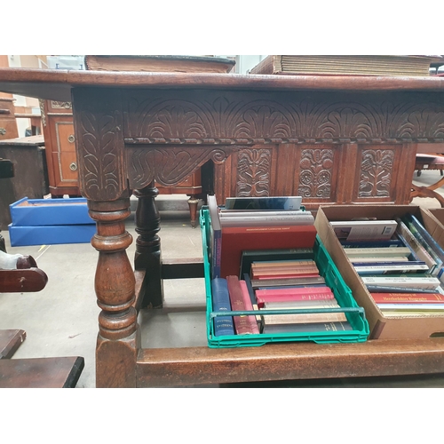 601 - A 17th Century oak Refectory Table with cleated three plank top above leafage arcade carved frieze r... 