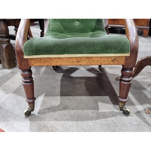 645 - A mahogany framed deep seated open Armchair/Library Chair with green button upholstery, raised on tu... 