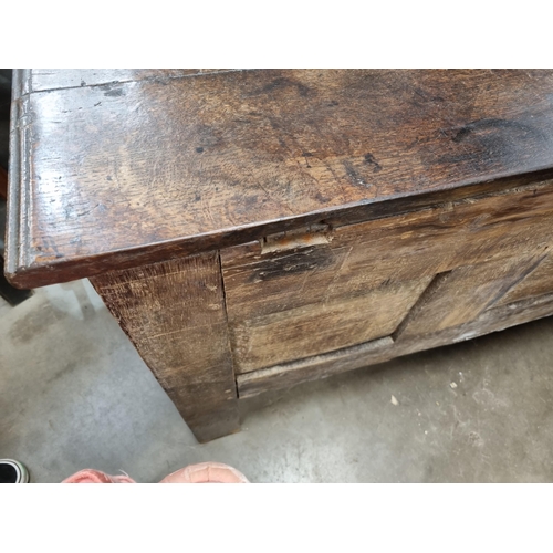 632 - A Lancashire oak Coffer with carved floral frieze, above stylised floral carved panels, bearing the ... 