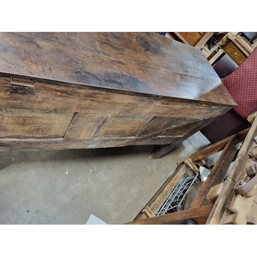 632 - A Lancashire oak Coffer with carved floral frieze, above stylised floral carved panels, bearing the ... 