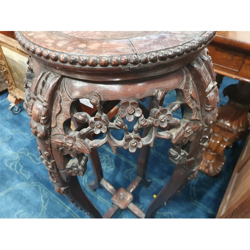 860 - A Chinese hardwood Jardiniere Stand with inset marble top surrounded by a beaded edge, the shaped su... 