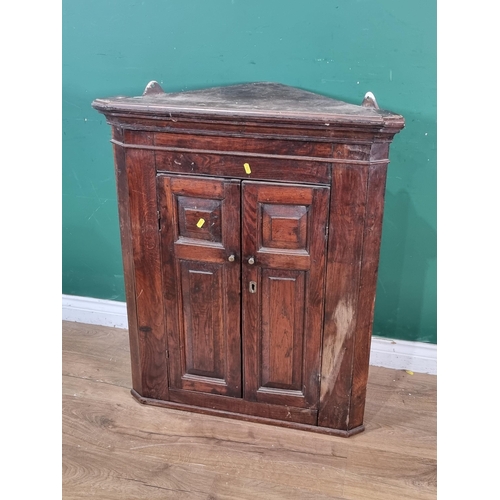 444 - An antique oak hanging Corner Cupboard fitted two panel doors 3ft H x 2ft 5in W. (R2).