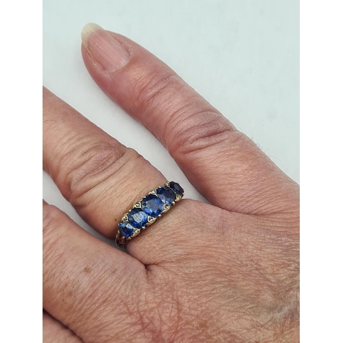 177 - A Victorian five stone Sapphire Ring by Mappin & Webb claw-set graduated oval mixed cut stones of fi... 