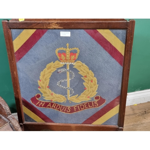 100 - A carved oak Coal Hod and a Firescreen with wool work panel depicting Royal Army Medical corps Regim... 