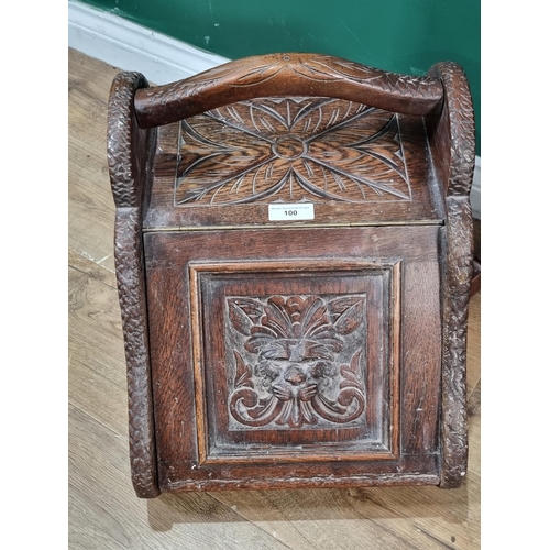 100 - A carved oak Coal Hod and a Firescreen with wool work panel depicting Royal Army Medical corps Regim... 