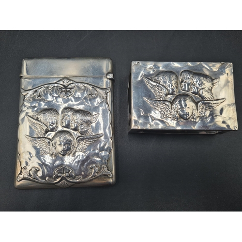 101 - A Victorian silver Card Case embossed cherub masks, etc, London 1900, maker: Wm Comyns, and a matchi... 