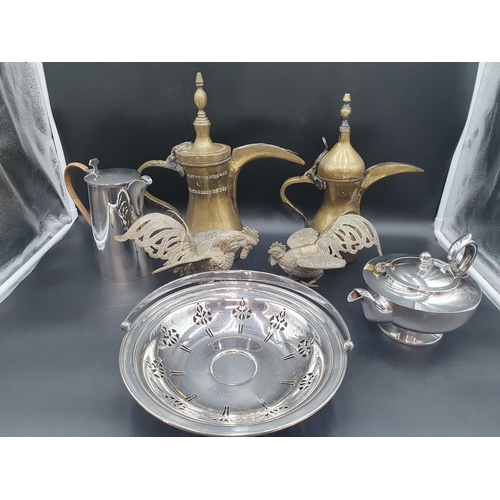 141 - Two brass Omani Coffee Pots, pair of Jordanian Fighting Cocks, a plated Teapot, Hot Water Jug and Ca... 